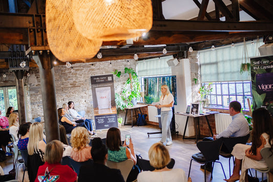 Rachel Woolford giving a presentation to an audience in a modern office setting. 10