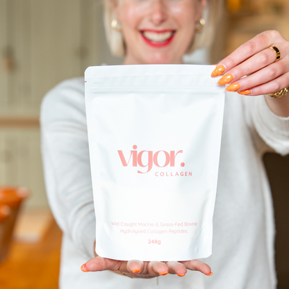 Person holding a package of vigor COLLAGEN in a kitchen setting