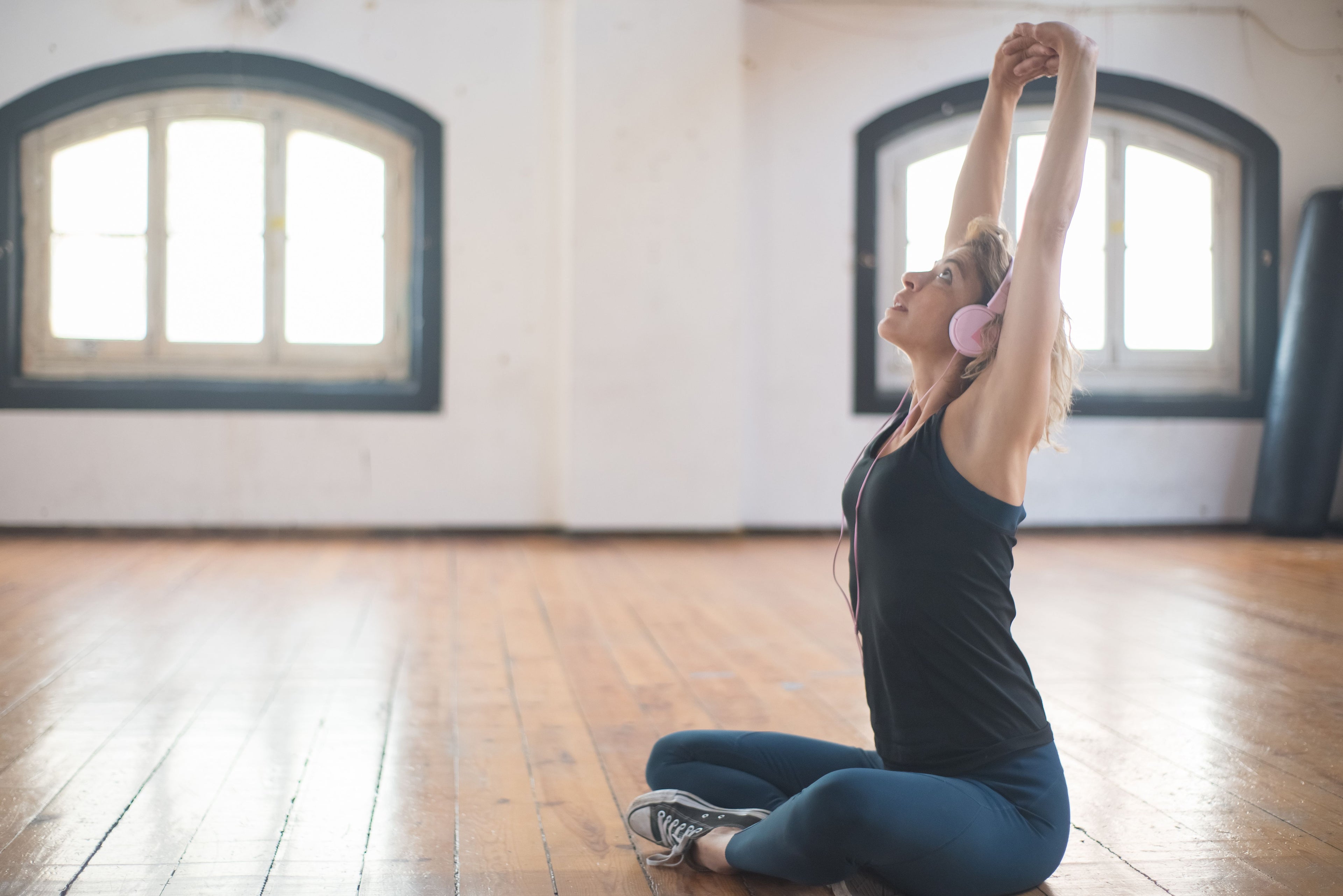 Vigor Vitamins High Quality Supplements - Woman Sitting on floor stretching